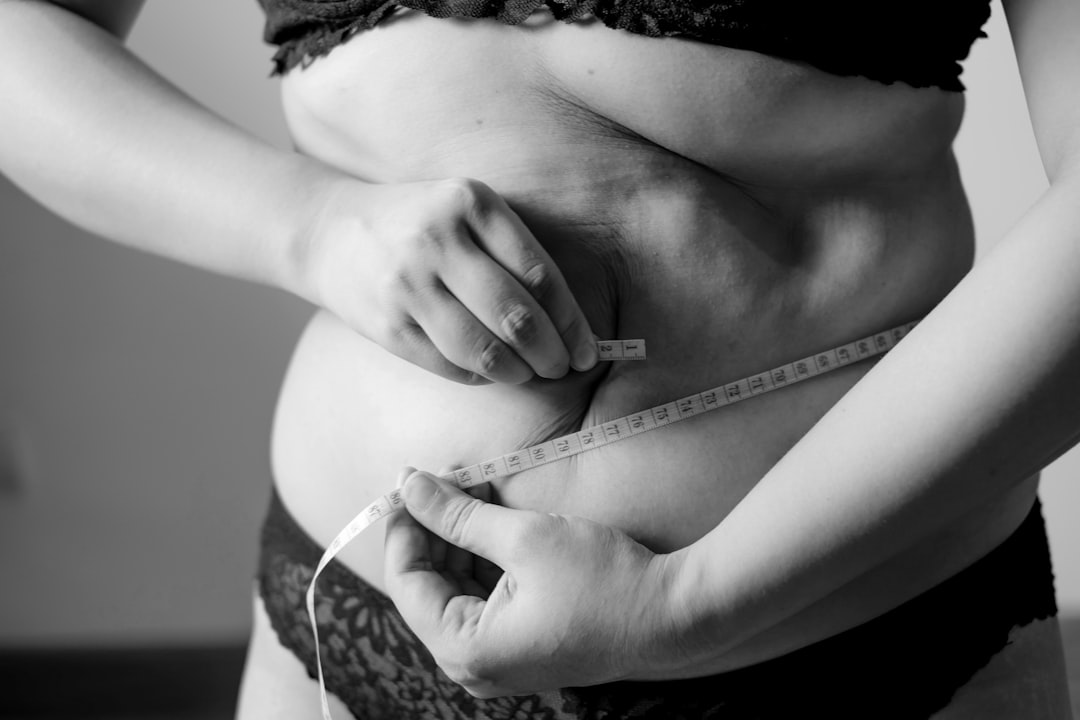 Photo by Fuu J grayscale photo of woman holding her breast